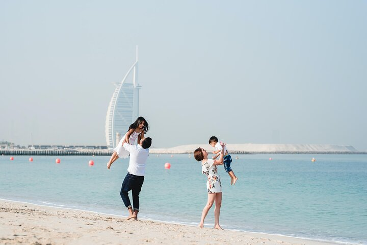 Experience Dubai's stunning skyline while enjoying quality family time on the beach where iconic landmarks like the Burj Al Arab provide a picturesque backdrop for unforgettable memories.